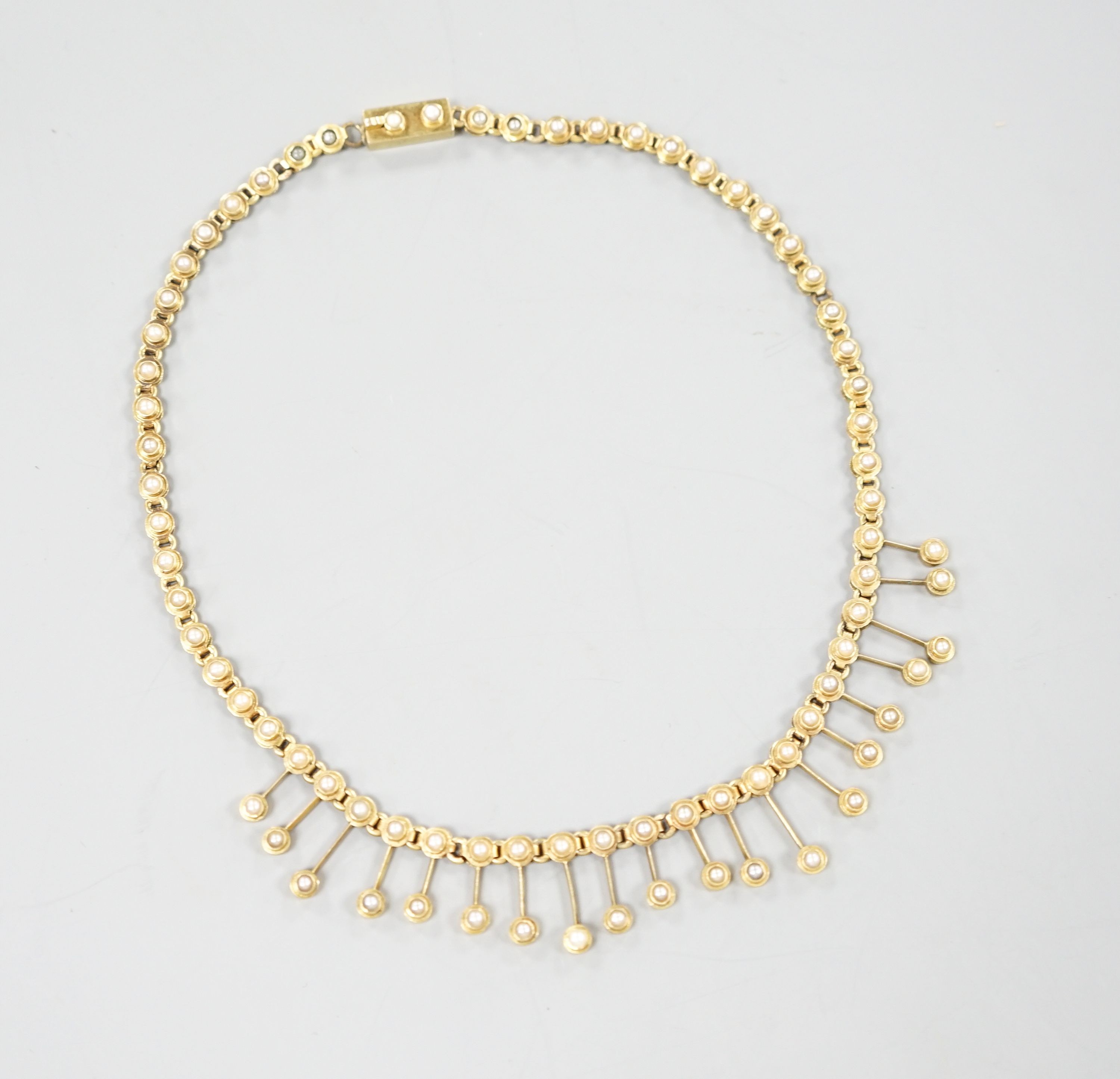 A late Victorian yellow metal and seed pearl set fringe choker necklace, 33cm, gross 18.4 grams.